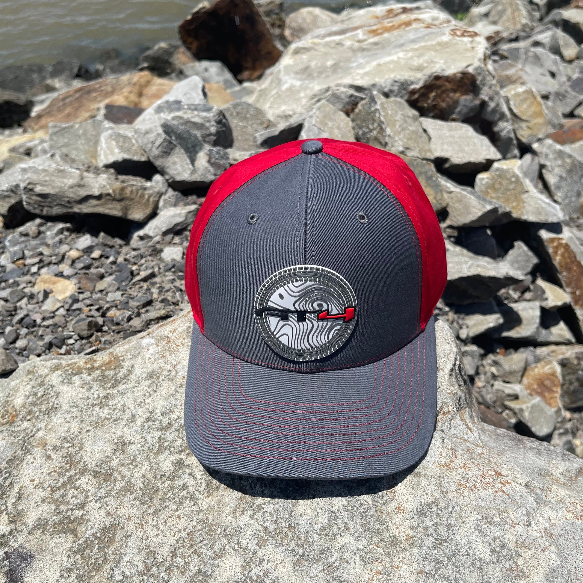 AT4 3D Topo Twill Back Trucker Hat- Charcoal/ Red - Ten Gallon Hat Co.